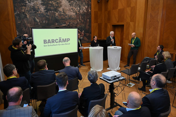 Schule BARCÄMP „Ein Schulfach für den Beruf“ Ministerpräsident Winfried Kretschmann und Kultusministerin Theresa Schopper sprechen zu den Teilnehmenden.