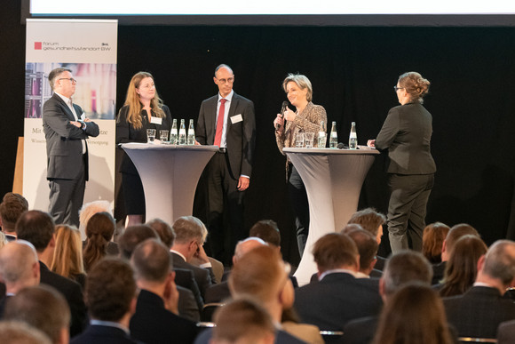 Konferenz Zwischenbilanz des Forums Gesundheitsstandort v.l.n.r.: Prof. Dr. Hagen Pfundner (Vorstand der Roche Pharma AG), Prof. Dr. rer. nat. Katja Schenke-Layland (Universität Tübingen), Bernd Rühle (Leitung Diakonie-Klinikum Stuttgart), Dr. Nicole Hoffmeister-Kraut (Wirtschaftsministerin Baden-Württemberg), Angelika Mensold (Moderatorin) (Foto: Staatsministerium Baden-Württemberg)